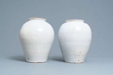 A pair of large Dutch Delft blue and white tobacco jars with the arms of Amsterdam, 18th C.