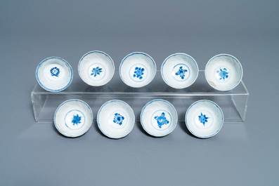 A collection of Chinese and Japanese blue and white cups and saucers and two ewers, Wanli and later