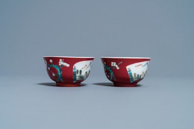 A pair of Chinese famille rose ruby-ground cups and saucers, Yongzheng