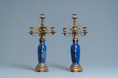 A pair of Chinese blue-ground vases with bronze candelabra mounts, Kangxi and 19th C.