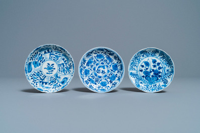 A collection of Chinese and Japanese blue and white cups and saucers and two ewers, Wanli and later