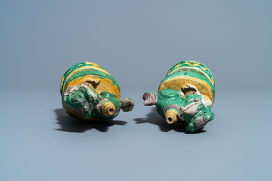 A pair of Chinese sancai-glazed biscuit Buddhist lion joss stick holders, Ming