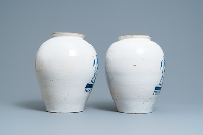 A pair of large Dutch Delft blue and white tobacco jars with the arms of Amsterdam, 18th C.