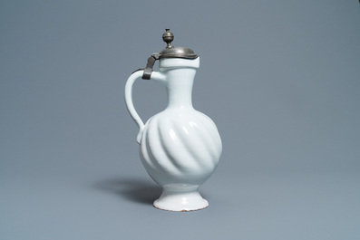 A large gadrooned white Dutch Delftware jug with pewter cover, 17th C.