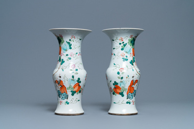 A pair of Chinese famille rose vases with boys hanging near pumpkins, 19th C.