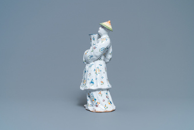 A polychrome French faience candle holder in the shape of a Chinaman, Lille, 18th C.