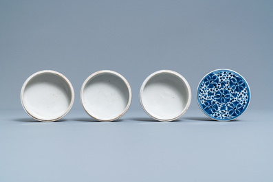 A pair of Chinese blue and white three-tier stacking boxes, a seal paste box and four saucers, 19th C.