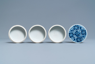 A pair of Chinese blue and white three-tier stacking boxes, a seal paste box and four saucers, 19th C.