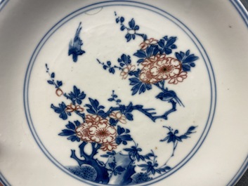 A Chinese blue, white and copper-red saucer dish with floral design, Kangxi