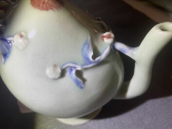 A Chinese relief-decorated peach-shaped 'cadogan' teapot in copper-red and blue on celadon-ground, 19th C.
