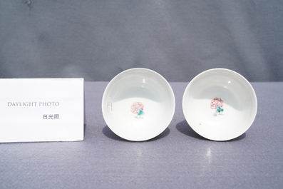 A pair of Chinese famille rose ruby-ground cups and saucers, Yongzheng