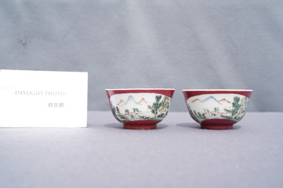 A pair of Chinese famille rose ruby-ground cups and saucers, Yongzheng