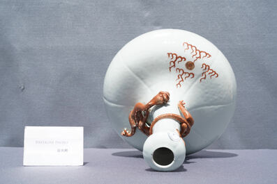 A Chinese white-glazed garlic head vase with an applied dragon, 19th C.