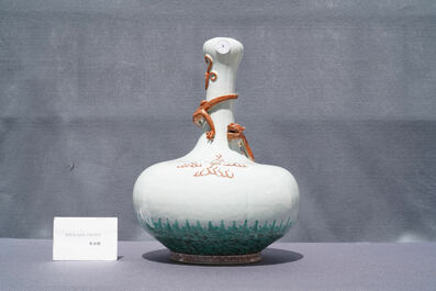 A Chinese white-glazed garlic head vase with an applied dragon, 19th C.
