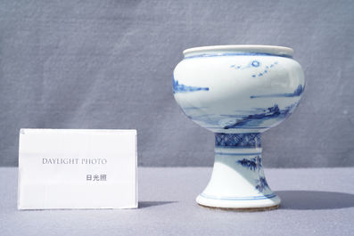 A Chinese blue and white stem cup with a continuous landscape scene, Kangxi/Yongzheng