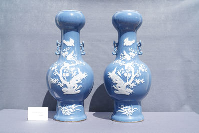 A pair of Chinese white slip-decorated blue-ground vases, 19th C.