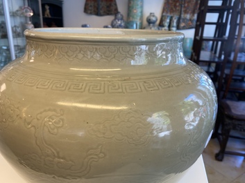 A globular Chinese monochrome celadon 'dragon' vase, Kangxi