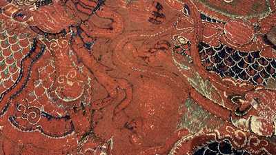 A large Chinese horizontal embroidered red-ground textile panel, 19th C.