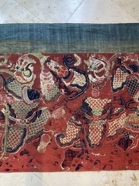 A large Chinese horizontal embroidered red-ground textile panel, 19th C.