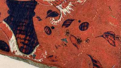 A large Chinese horizontal embroidered red-ground textile panel, 19th C.