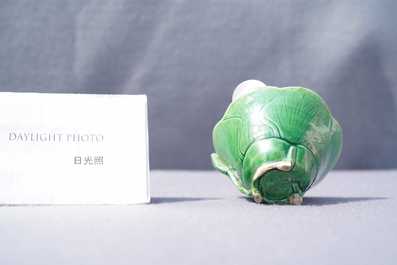 A Chinese 'egg and spinach'-glazed lotus cup and saucer with applied design, Kangxi