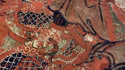 A large Chinese horizontal embroidered red-ground textile panel, 19th C.