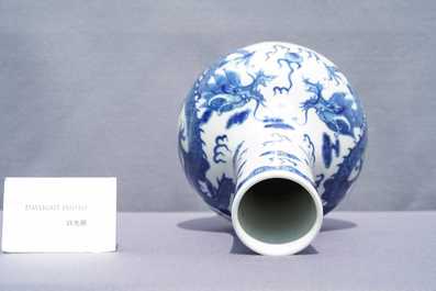 A Chinese blue and white 'dragons' bottle vase, Yongzheng mark, 19th C.