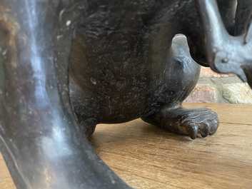 A pair of large Chinese bronze models of Buddhist lions, Ming