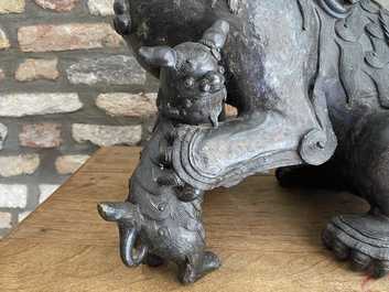 A pair of large Chinese bronze models of Buddhist lions, Ming