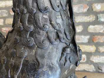 A pair of large Chinese bronze models of Buddhist lions, Ming