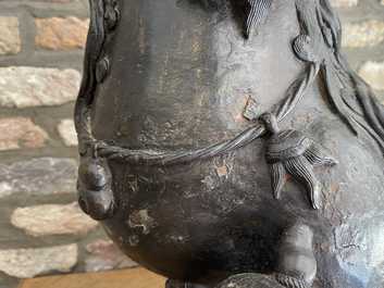 A pair of large Chinese bronze models of Buddhist lions, Ming