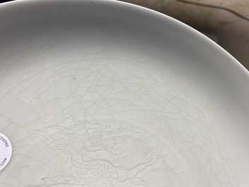 A Chinese monochrome celadon underglaze 'dragon' dish, Qianlong/Jiaqing