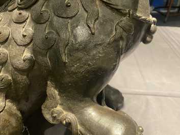 A pair of large Chinese bronze models of Buddhist lions, Ming