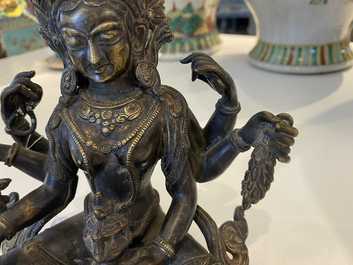 A Nepalese solid bronze figure of Vasudhara, 19th C.