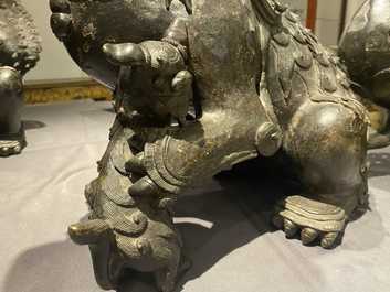 A pair of large Chinese bronze models of Buddhist lions, Ming