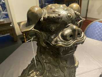 A pair of large Chinese bronze models of Buddhist lions, Ming