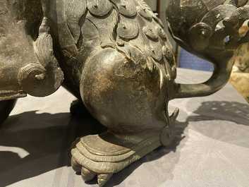 A pair of large Chinese bronze models of Buddhist lions, Ming