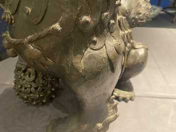 A pair of large Chinese bronze models of Buddhist lions, Ming