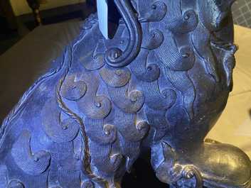 A pair of large Chinese bronze models of Buddhist lions, Ming