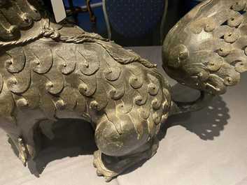 A pair of large Chinese bronze models of Buddhist lions, Ming