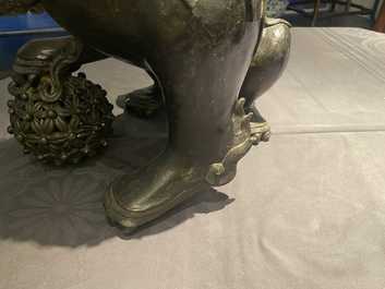 A pair of large Chinese bronze models of Buddhist lions, Ming