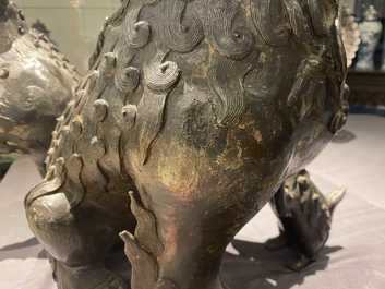 A pair of large Chinese bronze models of Buddhist lions, Ming