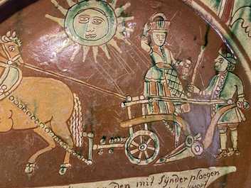 A German slip-decorated inscribed pottery dish with a ploughing farmer, Lower Rhine region, 2nd half 18th C.