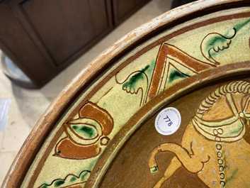 A German slip-decorated inscribed pottery dish with a ploughing farmer, Lower Rhine region, 2nd half 18th C.