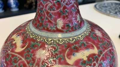 A Chinese famille rose ruby-ground bottle vase, Qianlong mark, 19/20th C.