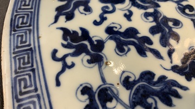 A large Chinese round blue and white plaque with floral design, 19th C.