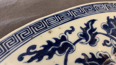A large Chinese round blue and white plaque with floral design, 19th C.