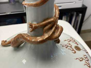 A Chinese white-glazed garlic head vase with an applied dragon, 19th C.