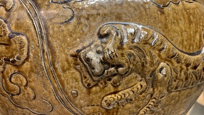 A large Chinese brown-glazed relief-molded martaban jar with Buddhist lions, Ming