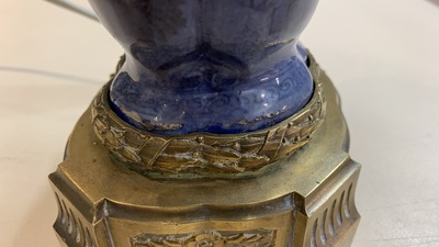 A pair of Chinese blue-ground vases with bronze candelabra mounts, Kangxi and 19th C.